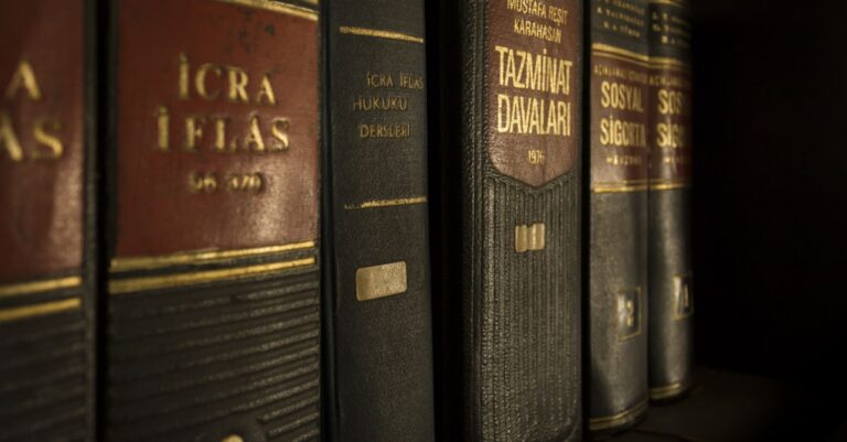 Detailed close-up of law and regulation books on a bookshelf, emphasizing education and knowledge.